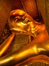 Beautiful face of Reclining Buddha, and thai art architecture in Wat Phra Chetupon Vimolmangklararm Wat Pho temple They are