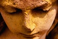 Beautiful face of sad angel. Ancient stone statue. Fragment Royalty Free Stock Photo