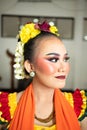 beautiful face of a traditional Indonesian dancer wearing flowers and charming makeup before performing Royalty Free Stock Photo