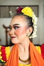 beautiful face of a traditional Indonesian dancer wearing flowers and charming makeup before performing Royalty Free Stock Photo