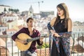 Beautiful fado singer performing with handsome portuguese guitar