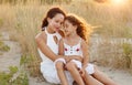 Mother hug daughter on the sea beach. Happy family in vacation and travel. Mom hug tender her daughter at the sea Royalty Free Stock Photo