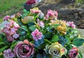 Beautiful fake flowers on a gravestone