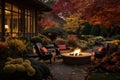 Beautiful fall garden, residential backyard with outdoor chairs and fire-pit with flame, cozy autumn lanscape design Royalty Free Stock Photo