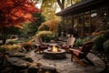 Beautiful fall garden, residential backyard with outdoor chairs and fire-pit with flame, cozy autumn lanscape design