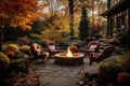 Beautiful fall garden, residential backyard with outdoor chairs and fire-pit with flame, cozy autumn lanscape design Royalty Free Stock Photo