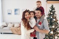 Beautiful family celebrates New year and christmas indoors at home