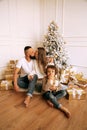 Beautiful family celebrating Christmas with decorated tree and presents Royalty Free Stock Photo