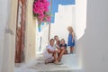 Beautiful family of four sitting on doorstep at Royalty Free Stock Photo