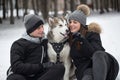 Beautiful family, a man and a girl in winter forest with dog. Play with the dog Siberian husky.