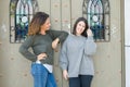 Beautiful family of mother and daughter smiling cheerful, two happy women together leaning on each other as woman power Royalty Free Stock Photo