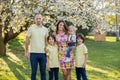 Beautiful family, mother, father and three kids, boys, having familly outdoors portrait taken on a sunny spring evening, beautiful Royalty Free Stock Photo