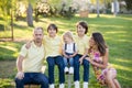 Beautiful family, mother, father and three kids, boys, having familly outdoors portrait taken on a sunny spring evening, beautiful Royalty Free Stock Photo