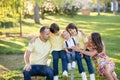 Beautiful family, mother, father and three kids, boys, having familly outdoors portrait taken on a sunny spring evening, beautiful Royalty Free Stock Photo