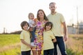 Beautiful family, mother, father and three kids, boys, having familly outdoors portrait taken on a sunny spring evening, beautiful Royalty Free Stock Photo
