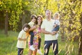 Beautiful family, mother, father and three kids, boys, having familly outdoors portrait taken on a sunny spring evening, beautiful Royalty Free Stock Photo