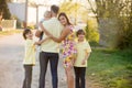 Beautiful family, mother, father and three kids, boys, having familly outdoors portrait taken on a sunny spring evening, beautiful Royalty Free Stock Photo