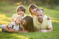 Beautiful family, mother, father and three kids, boys, having familly outdoors portrait taken on a sunny spring evening, beautiful Royalty Free Stock Photo