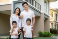 Beautiful family portrait smiling outside their new house with a key Royalty Free Stock Photo
