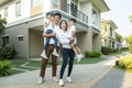 Beautiful family portrait smiling outside their new house with sunset Royalty Free Stock Photo