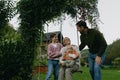 Beautiful family swinging on swing in the garden, having fun and spending quality time together outdoors during warm Royalty Free Stock Photo