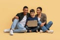 Beautiful family watching movie together, using laptop Royalty Free Stock Photo