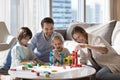 Happy family with kids playing wooden blocks at modern home Royalty Free Stock Photo