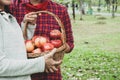 Beautiful family woman smile holding and eating apples at park. Royalty Free Stock Photo