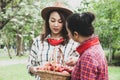 Beautiful family woman smile holding and eating apples at park. Royalty Free Stock Photo