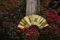 Beautiful fan with chinese phrase on a tree of pink flowers