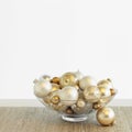 Beautiful, fancy silver and gold Christmas ornaments in glass bowl with white background. Simple, modern, luxe, luxury holiday