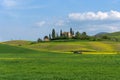 Beautiful farmland rural landscape, cypress trees and colorful spring flowers in Tuscany, Italy. Typical rural house Royalty Free Stock Photo