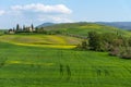 Beautiful farmland rural landscape, cypress trees and colorful spring flowers in Tuscany, Italy. Typical rural house Royalty Free Stock Photo