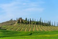 Beautiful farmland rural landscape, cypress trees and colorful spring flowers in Tuscany, Italy. Typical rural house Royalty Free Stock Photo