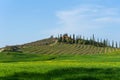 Beautiful farmland rural landscape, cypress trees and colorful spring flowers in Tuscany, Italy. Typical rural house Royalty Free Stock Photo