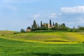 Beautiful farmland rural landscape, cypress trees and colorful spring flowers in Tuscany, Italy. Typical rural house Royalty Free Stock Photo