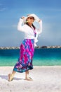 Beautiful fashion asian girl walks on beach Royalty Free Stock Photo