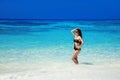 Beautiful fashion bikini girl model tanned On Tropical Beach. Outdoor portrait of slim brunette woman posing in exotic sea. Bliss Royalty Free Stock Photo