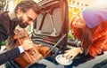 Beautiful fashion couple going to vacations, loading their car boot with leather travel suitcases  - Travel fashion and hipster Royalty Free Stock Photo