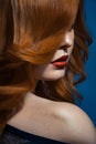 Beautiful fashion girl with long wavy red brown hair. fair-haired model with curly hairstyle and fashionable smoky makeup . Royalty Free Stock Photo