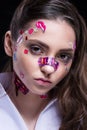 Beautiful fashion girl with luxury professional makeup and funny emoji stickers glued on the face.