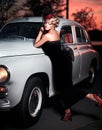 Fashion girl in retro style posing near old car Royalty Free Stock Photo