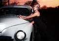 Fashion girl in retro style posing near old car Royalty Free Stock Photo