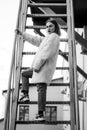 Beautiful fashion girl on stairs. Portrait of young pretty woman in black and white Royalty Free Stock Photo