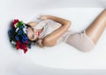 Beautiful Fashion model girl in milk bath with crown on head, sp Royalty Free Stock Photo