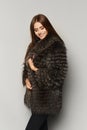 Beautiful fashion model girl with perfect makeup in luxury fur coat, isolated on the background. Fashion studio photo of Royalty Free Stock Photo