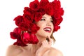 Beautiful fashion model girl with red roses on head Royalty Free Stock Photo