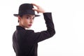 Beautiful fashion model holding her stylish black hat over white background in studio Royalty Free Stock Photo