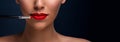 Beautiful fashion model`s red lips with bright makeup and cosmetic brush. Young woman with colored smoky eyes and mat red lips ma Royalty Free Stock Photo