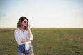 Beautiful and fashion portrait of awoman on green field